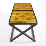 cast resin imprint of a cushion set into a metal frame/base with gilded detail