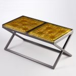 cast resin imprint of a cushion set into a metal frame/base with gilded detail