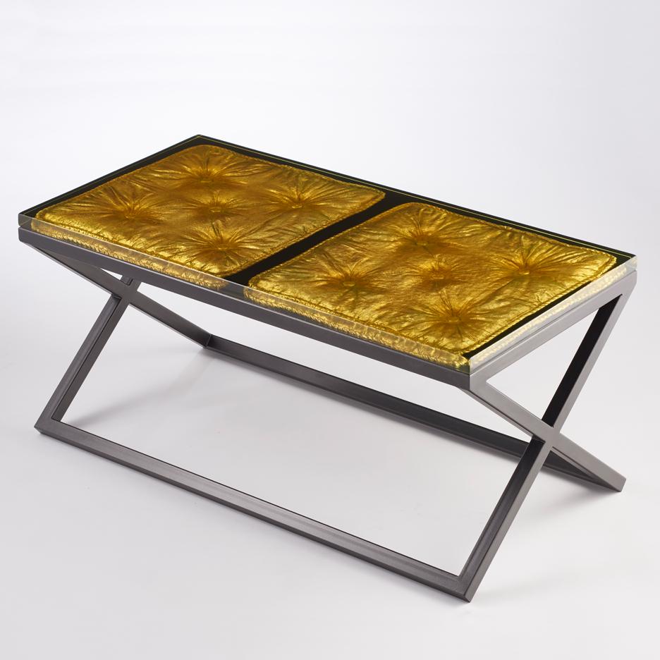 cast resin imprint of a cushion set into a metal frame/base with gilded detail