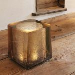 highly polished resin cast plinth illuminated by LED lights inside the textured core